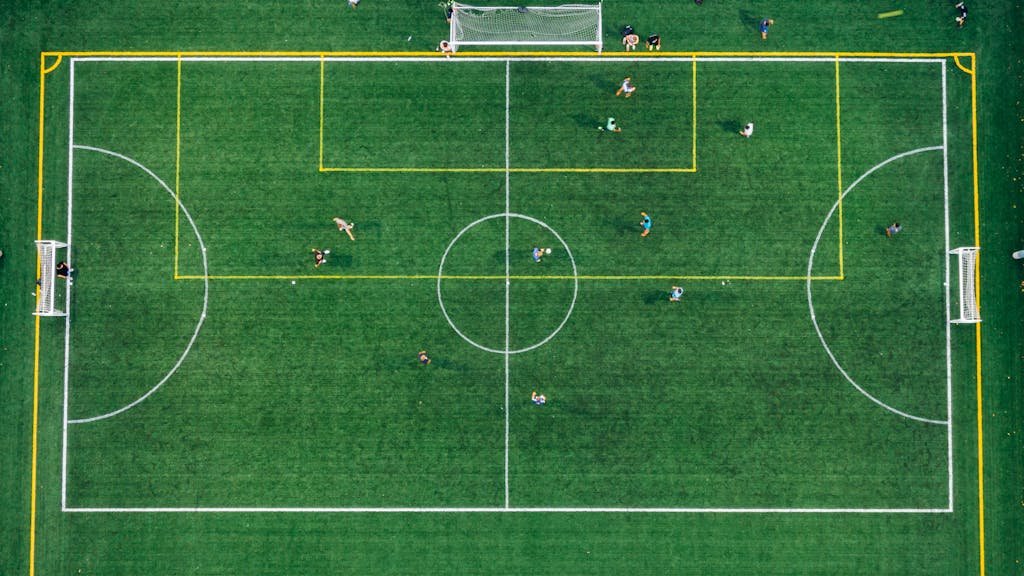 High aerial view of a soccer field with players during a game.