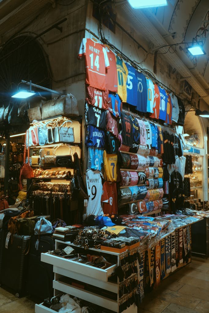 Vibrant market stall in Istanbul displaying a variety of colorful sports jerseys and merchandise.