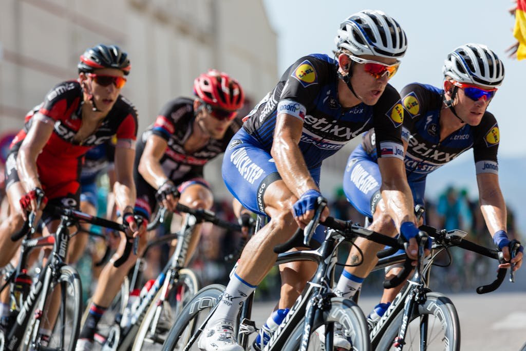 Competitive cyclists in a high-speed race, showcasing athleticism and teamwork.