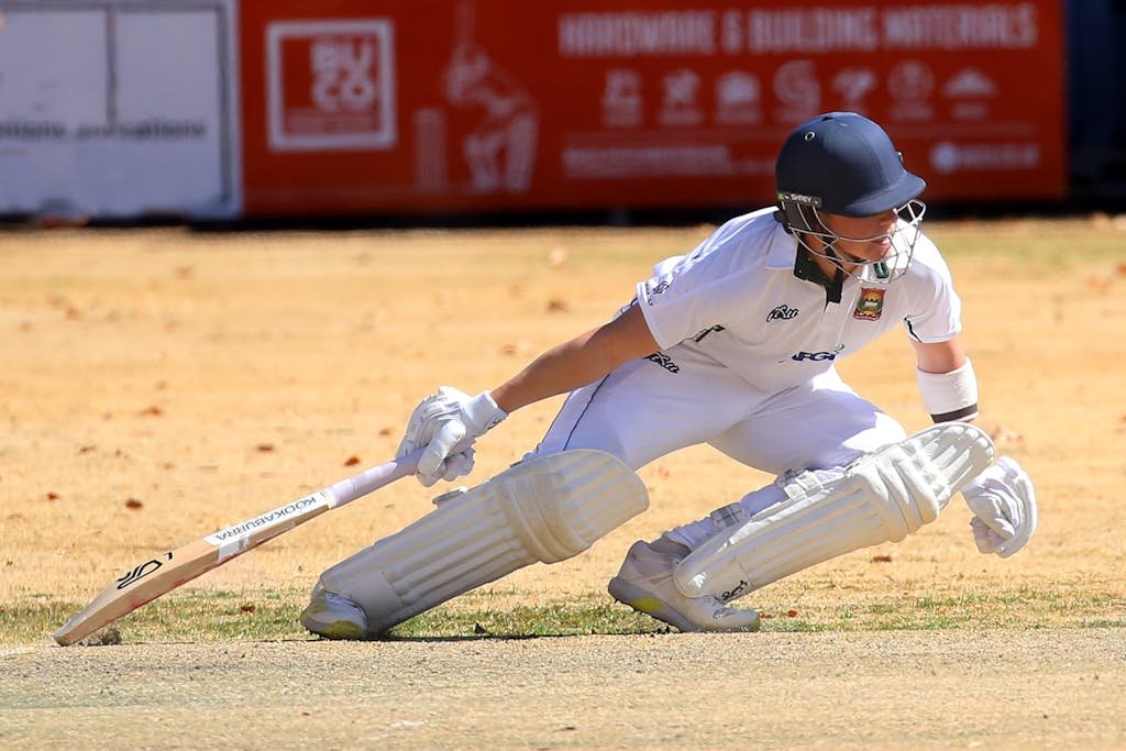 Dynamic shot of a cricketer playing during an intense outdoor match.