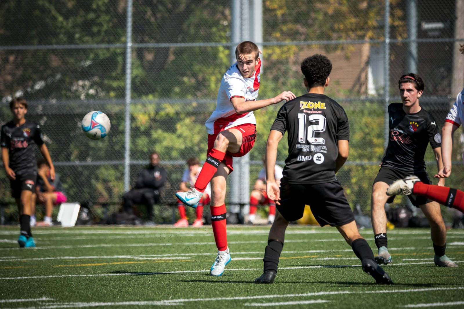 Dynamic scene of a youth soccer match in Montreal with focused players.