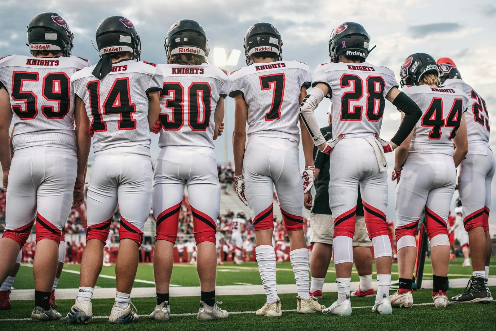 High school football team standing on the field ready for the game.